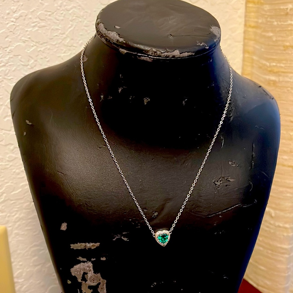 Heart pendant necklace with emerald and diamond like on a silver chain